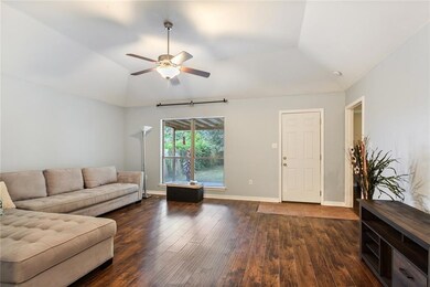 Den with gleaming laminate wood floors