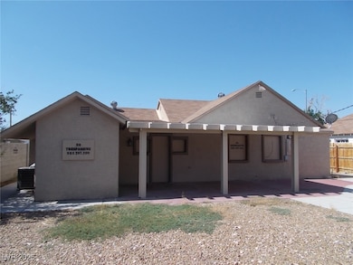 Rear view of house with a patio area and stucco si
