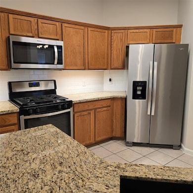 Modern kitchen with stainless steel appliances, gr