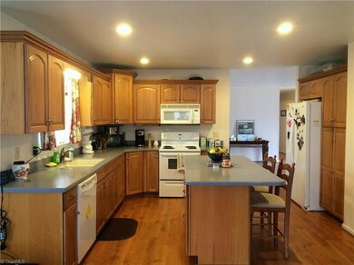 Den has entrance to back deck and garage and is open to the kitchen.