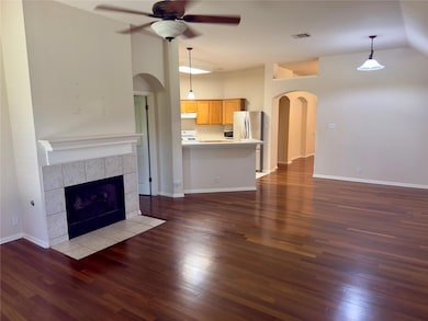 Unfurnished living room featuring arched walkways