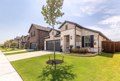 View of front of property with a garage and a front yard