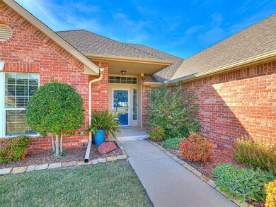 Entrance to property featuring a shingled roof, brick siding, and a lawn