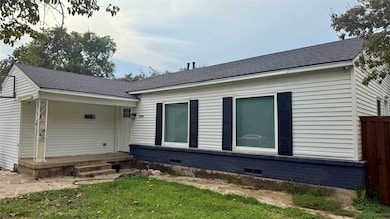 Back of property featuring a shingled roof, crawl space, and covered porch