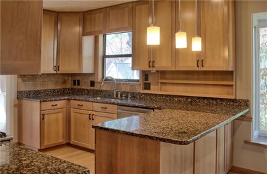 Kitchen featuring a sink, dark stone countertops, 