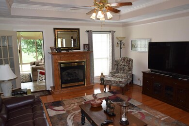 Living room with fireplace and access to the lovely sunroom!