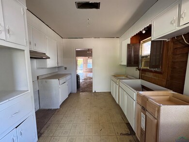 Kitchen featuring white cabinetry