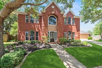 Beautifully landscaped with a mature tree, the 4BR