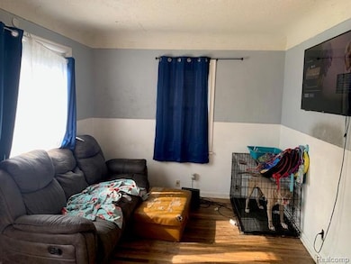 Living area featuring wood finished floors and a textured ceiling