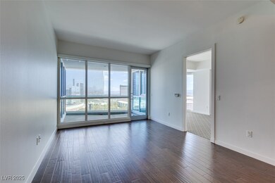Spare room featuring baseboards, dark wood-style f
