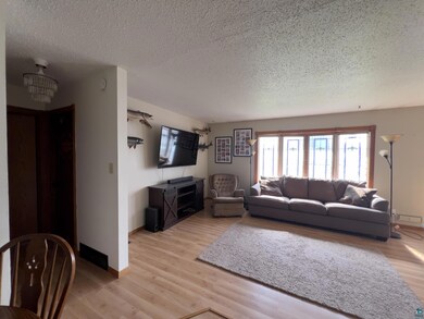 Living room with light hardwood / wood-style floor