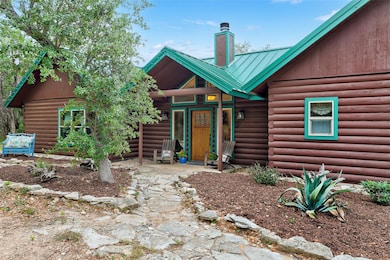 View of front of home featuring a chimney and met