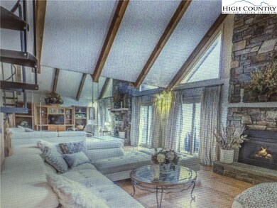 Livingroom with floor to ceiling stone fireplace.