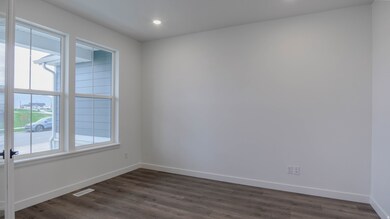 Spare room with dark wood finished floors and recessed lighting