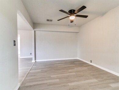 Unfurnished room featuring ceiling fan and light w