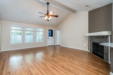 Tall ceilings with ceiling fan and wood burning fireplace to offer the best living environment