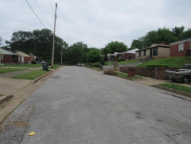 View of road featuring curbs, sidewalks, and a residential view