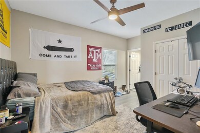 Bedroom with wood finished floors, ceiling fan, an