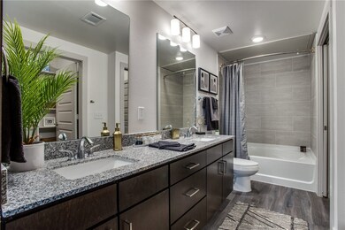 Full bathroom with toilet, vanity, shower / bath combination with curtain, and hardwood / wood-style flooring