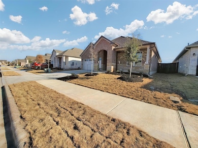 Single story home with brick siding, driveway, an