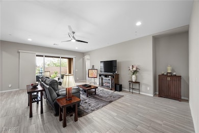 Living area featuring ceiling fan, baseboards, rec