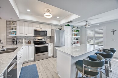 Kitchen featuring a raised ceiling, tasteful backs