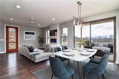 (Virtually Staged) Open concept living and dining rooms with modern fireplace, see downtown views from the windows! 9' ceilings on main floor with real oak hardwood flooring