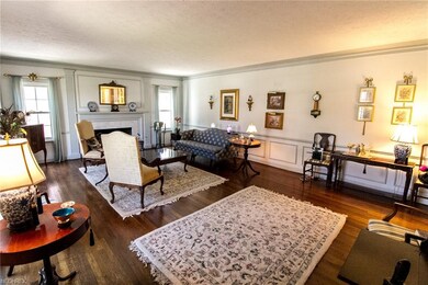Hiding behind the winged back chairs is a gas fire