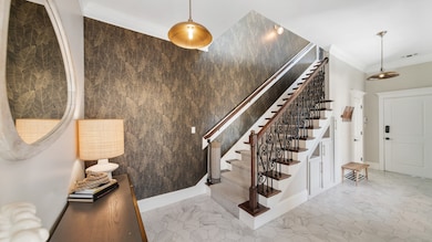 Upon entering you will be greeted right away with the grand staircase with iron details.