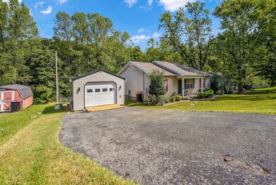 Paved driveway with detached garage.
