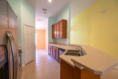 Kitchen towards front door. Reach-in pantry at left.