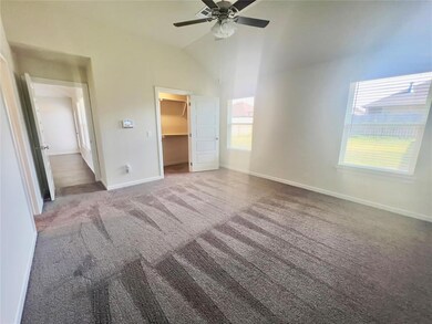 Unfurnished bedroom with ceiling fan, a spacious c