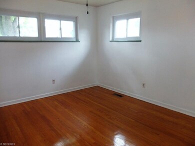First floor master bedroom with wood flooring.