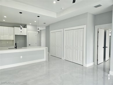 Kitchen with light countertops, visible vents, whi