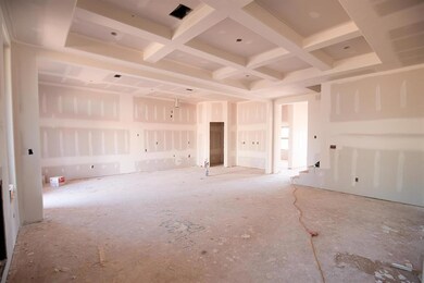 Unfurnished living room with beamed ceiling and coffered ceiling