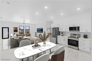 Kitchen with a ceiling fan, white cabinetry, reces