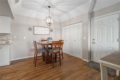 The Dining area has a beautiful hanging light fixture.