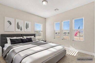 Carpeted bedroom featuring visible vents and baseb