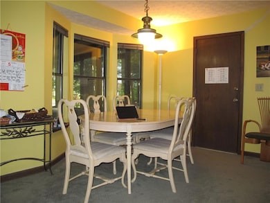 Carpeted dining room featuring baseboards