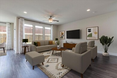Living area with baseboards, plenty of natural li