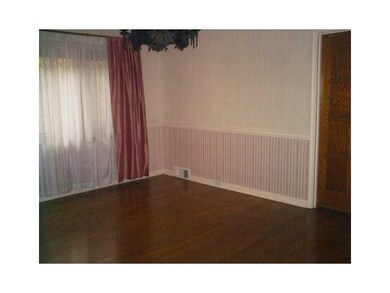 Dining Room. Hardwood Floors and Pocket Door to Ki