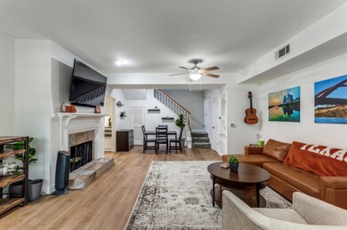 Living area with stairs, light wood-style floorin