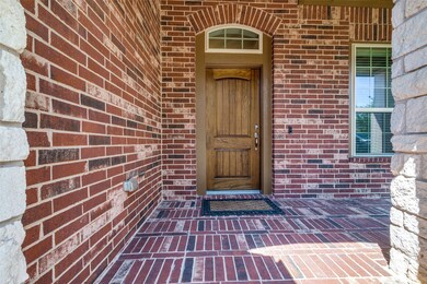 Welcome friends and family on this fully bricked front porch ideal for creative decorating year round.