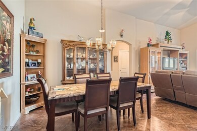 Dining area with arched walkways and a chandelier