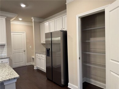 Kitchen featuring ornamental molding, stainless st