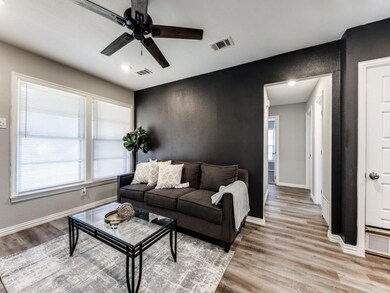 Living room featuring ceiling fan and light hardwo