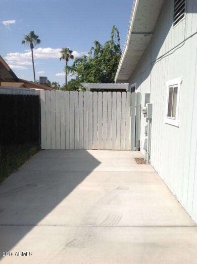 Front - driveway to closed gate