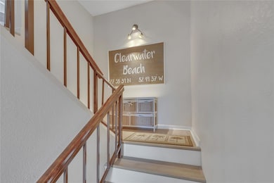 Stairs up from the entrance to the main living floor.