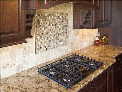 Gas cook top, granite, tile backsplash, undercount