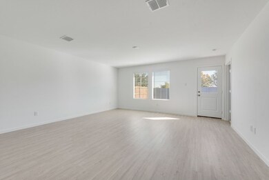 Unfurnished room featuring light wood finished floors and baseboards